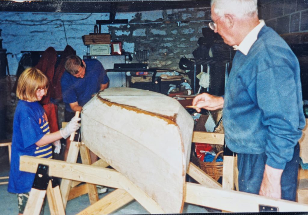 Polly Robinson as a child with her grandad and his boat