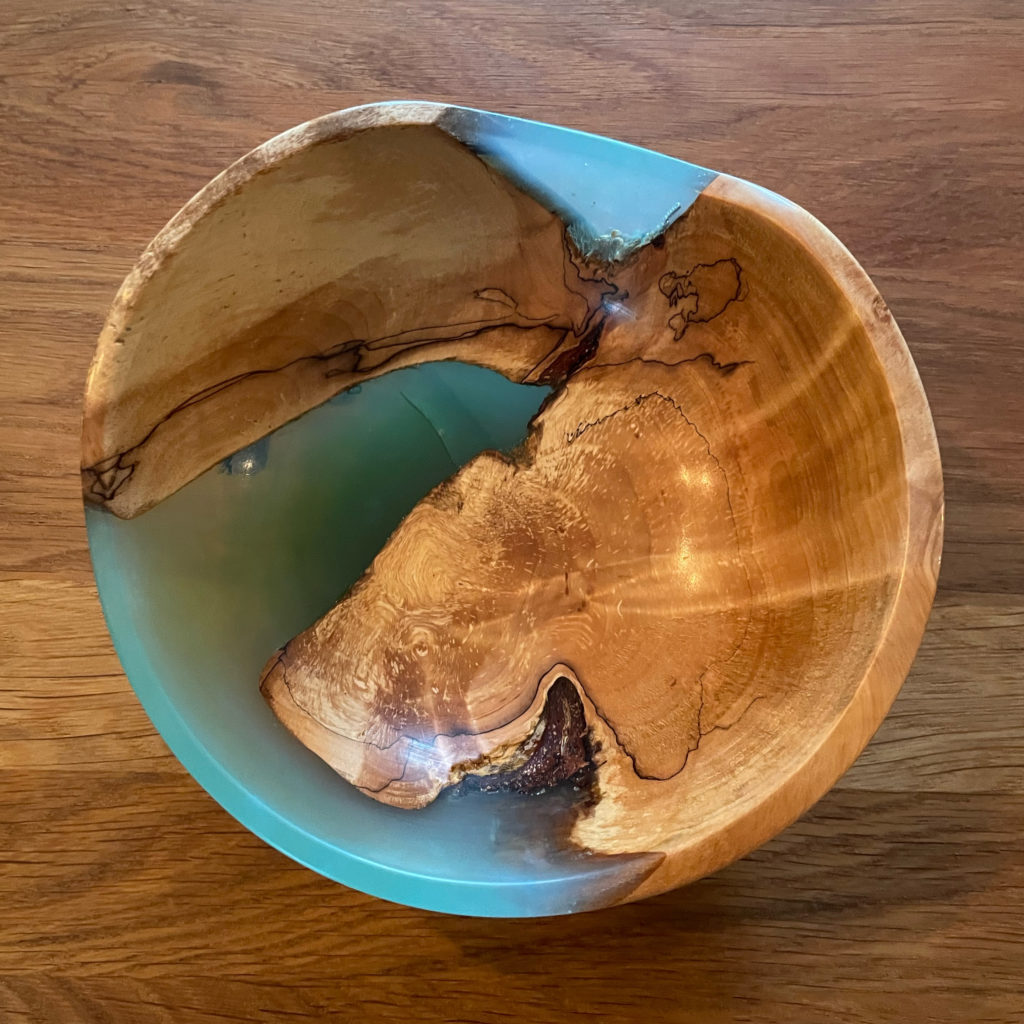 A bowl made from epoxy resin and wood.