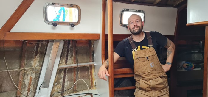 Shipwright stood in his sailboat.