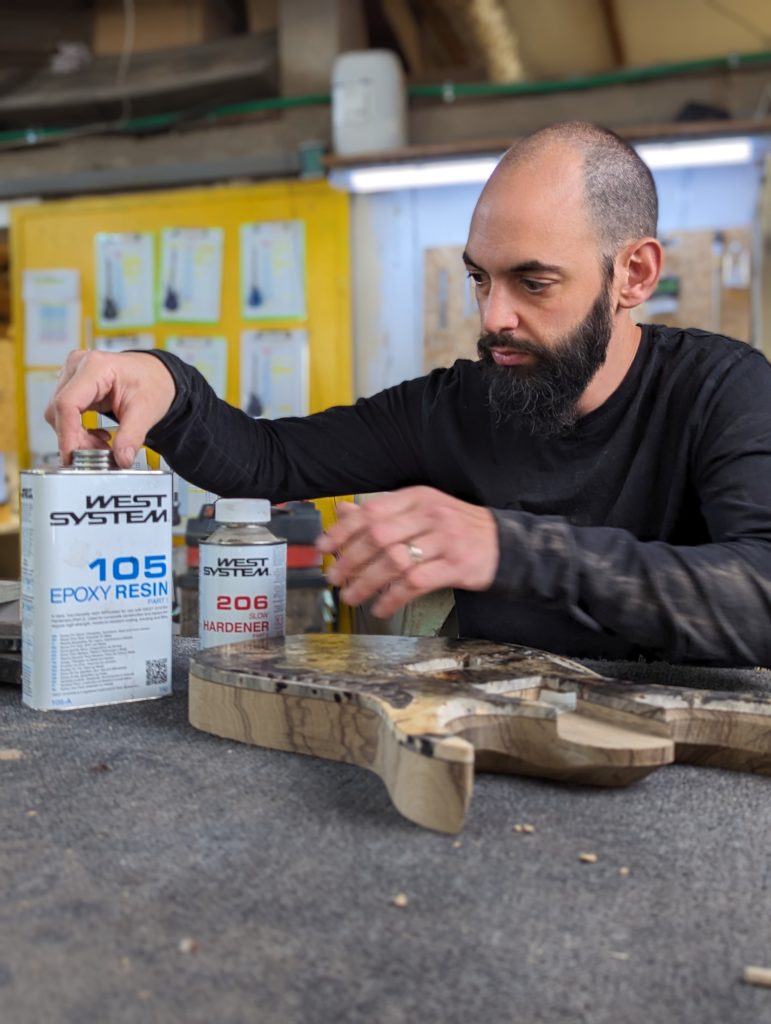 OD Guitars applying west system 105 epoxy resin and west system slow hardener to his wooden guitar