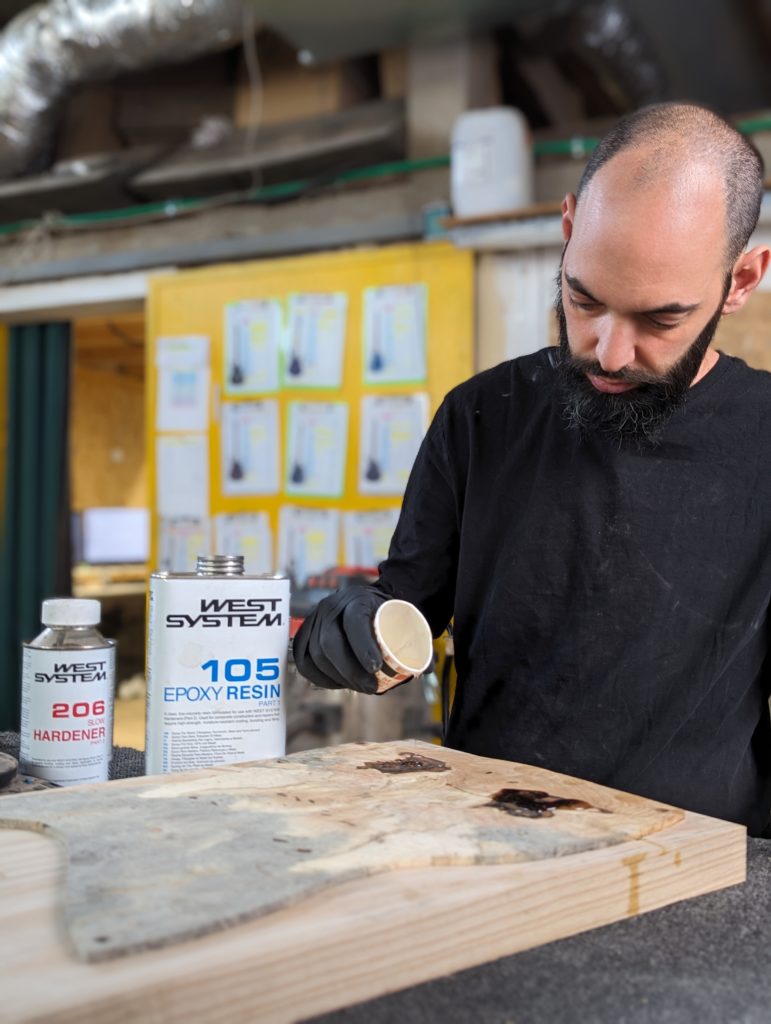 OD Guitars applying west system 105 epoxy resin and west system slow hardener to his wooden guitar