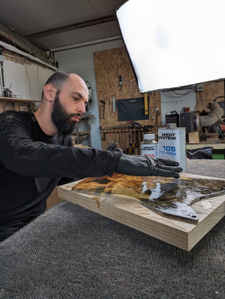 OD Guitars applying west system 105 epoxy resin and west system slow hardener to his wooden guitar