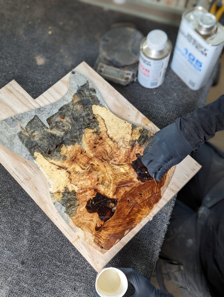 OD Guitars applying west system 105 epoxy resin and west system slow hardener to his wooden guitar