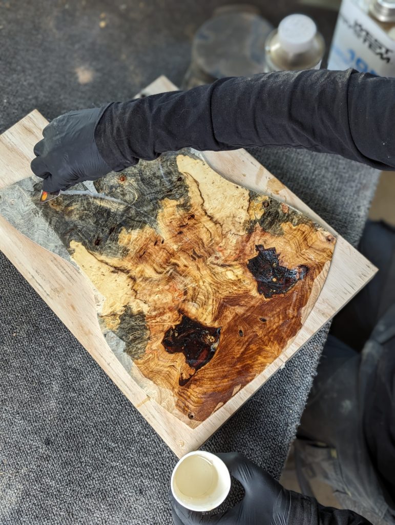 OD Guitars applying west system 105 epoxy resin and west system slow hardener to his wooden guitar