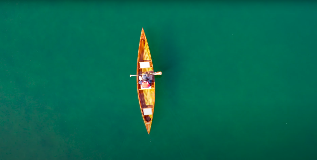 A wooden canoe built using west system epoxy in the water