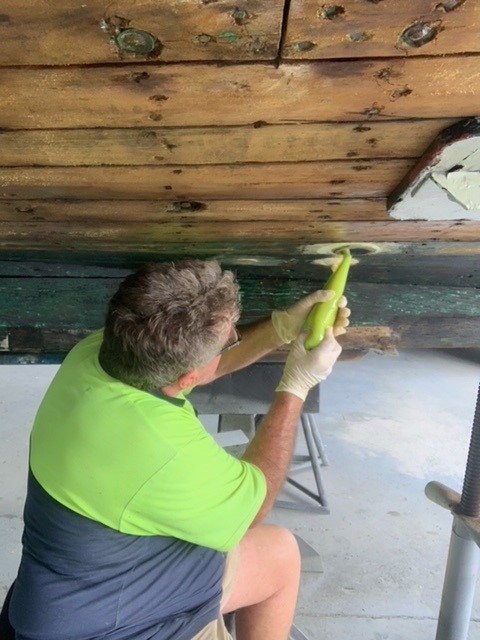 Glenn working on his boat, the 1960 timber cruiser.