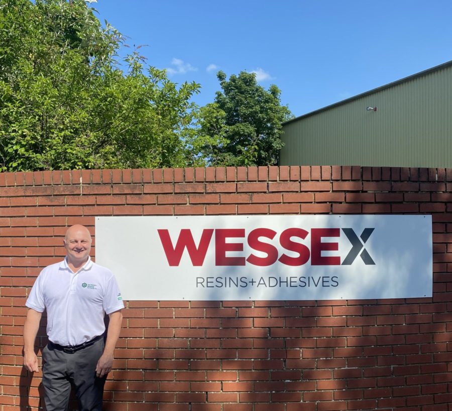 Julian smiles in front of the Wessex resins factory