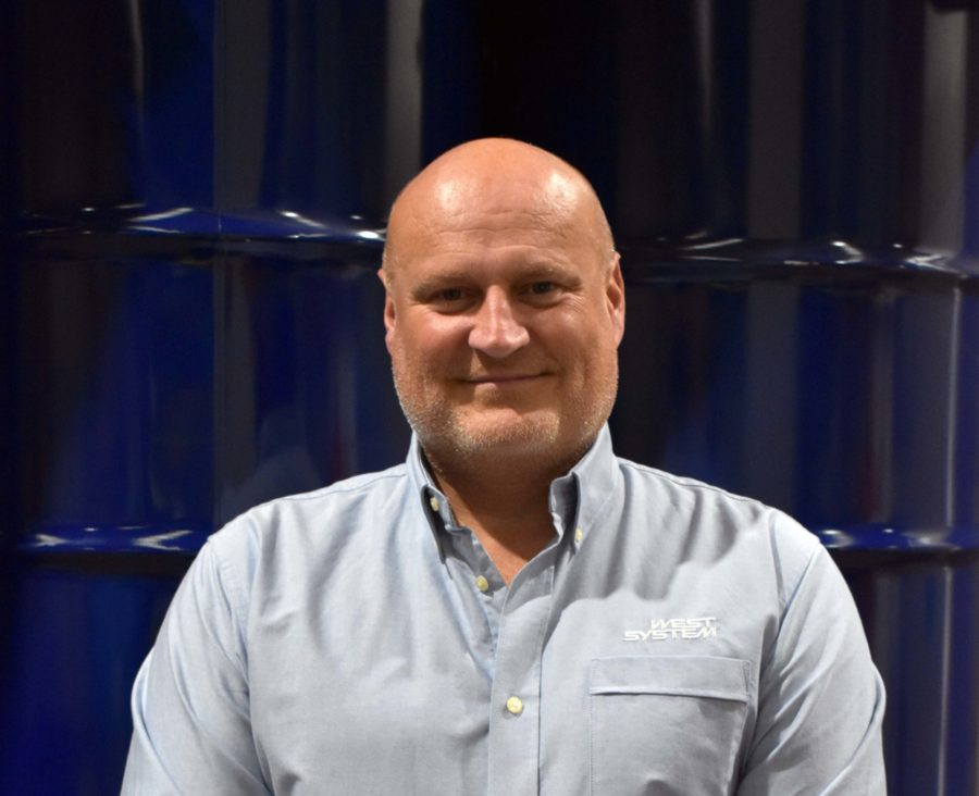 Headshot of Wessex Resins employee Martin Pickett in front of barrells