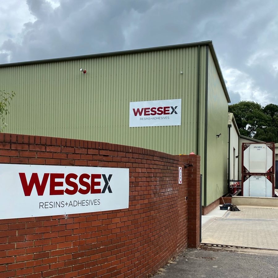 Wessex Resins factory exterior showing the logo on a brick wall