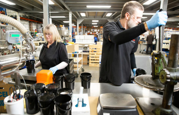 Wessex Resins staff pack containers in the warehouse