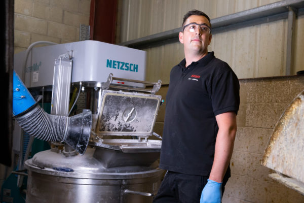 A Wessex Resins factory staff operates a machine