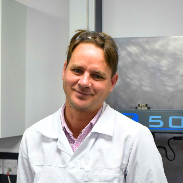 Headshot of Wessex Resins employee Luan Klue in a lab coat
