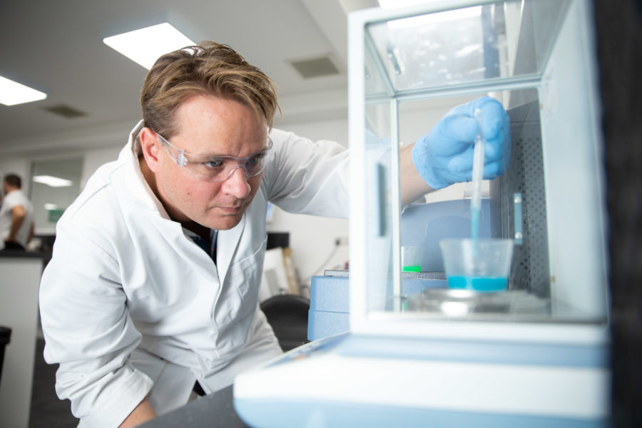 A Wessex Resins scientist uses a pipette to measure